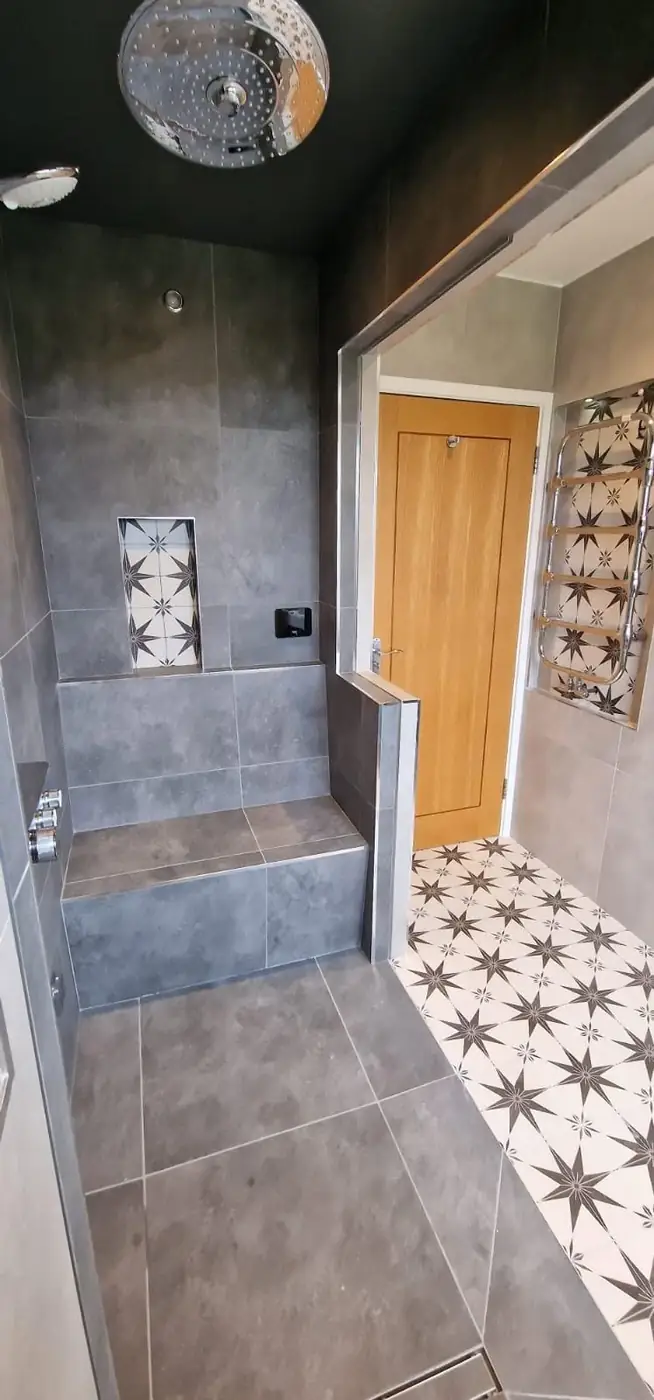 Shower room with grey wall tiles and a patterned floor